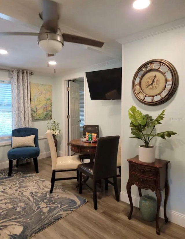 dining room with wood-type flooring and ornamental molding