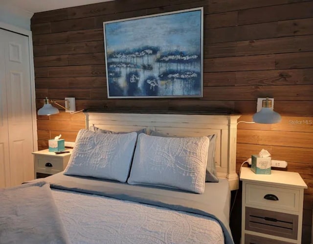 bedroom with wooden walls