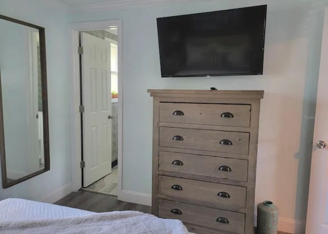 bedroom featuring crown molding and hardwood / wood-style floors