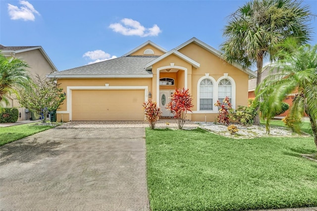 view of front facade with a front yard and a garage