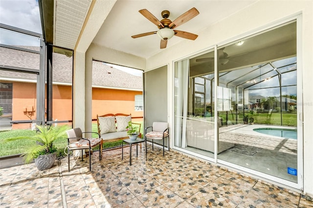 sunroom / solarium with plenty of natural light, ceiling fan, and a pool