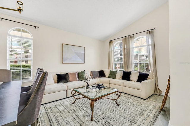 living room with plenty of natural light and vaulted ceiling