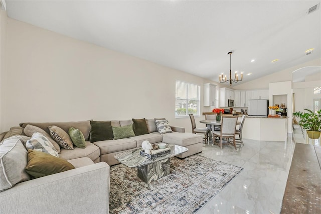 living room with an inviting chandelier and vaulted ceiling