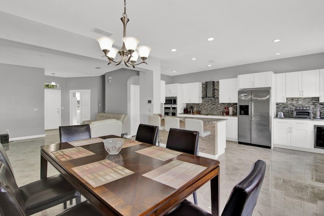 dining area with beverage cooler and a chandelier