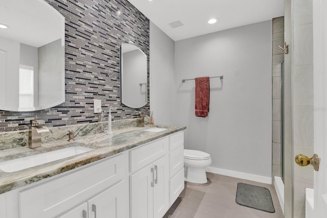 bathroom with walk in shower, vanity, toilet, and tasteful backsplash