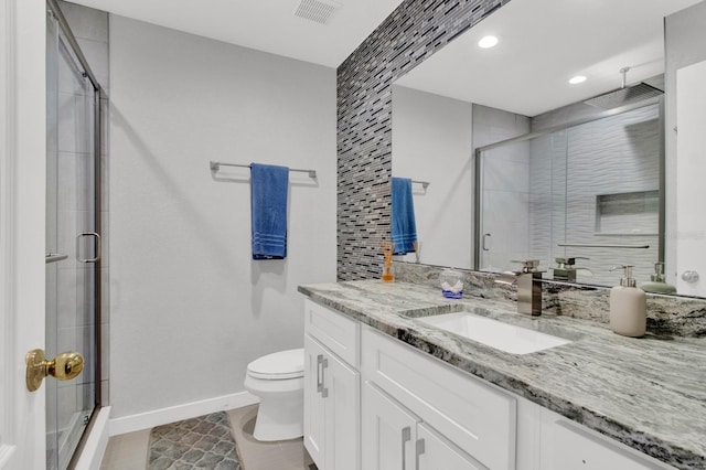 bathroom with tile patterned flooring, an enclosed shower, vanity, and toilet