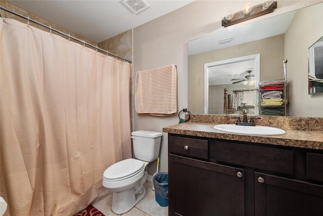 bathroom featuring a shower with shower curtain, tile patterned floors, toilet, ceiling fan, and vanity