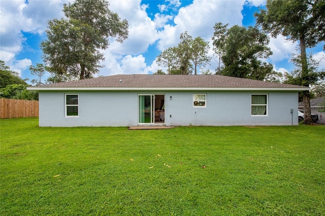 back of house featuring a lawn