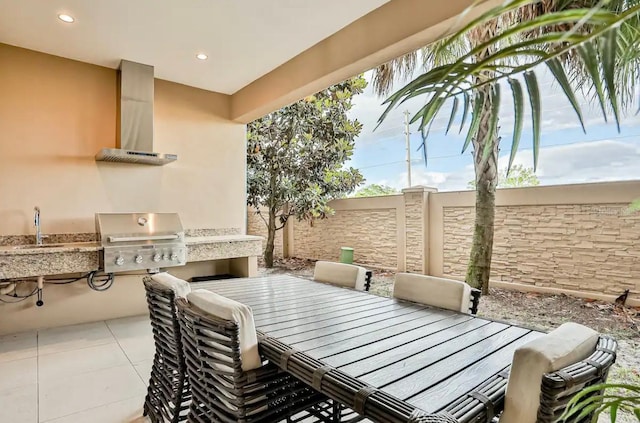 view of patio / terrace with area for grilling, sink, and a grill