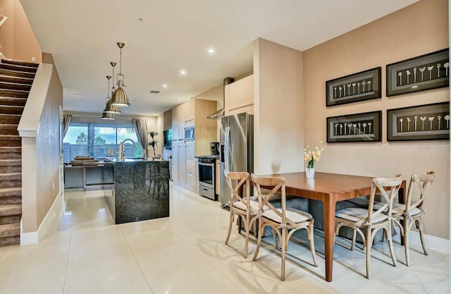 dining area featuring light tile patterned floors and sink