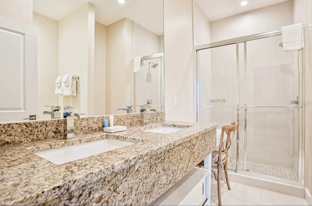 bathroom featuring tile patterned flooring, vanity, and a shower with shower door