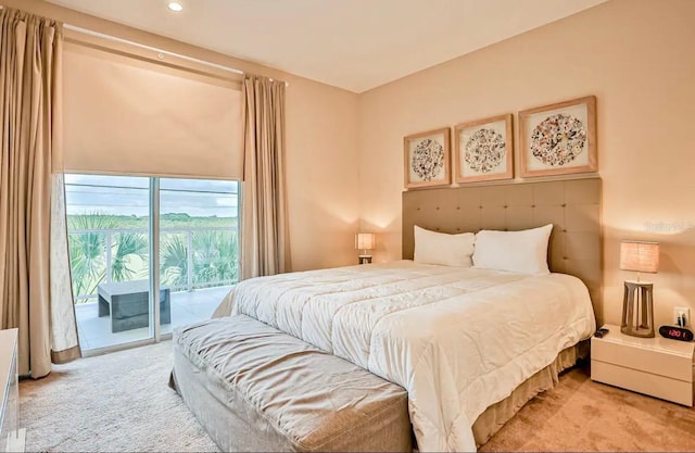 bedroom featuring light carpet and access to outside