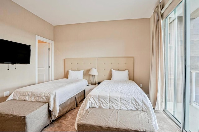 carpeted bedroom featuring multiple windows and access to outside