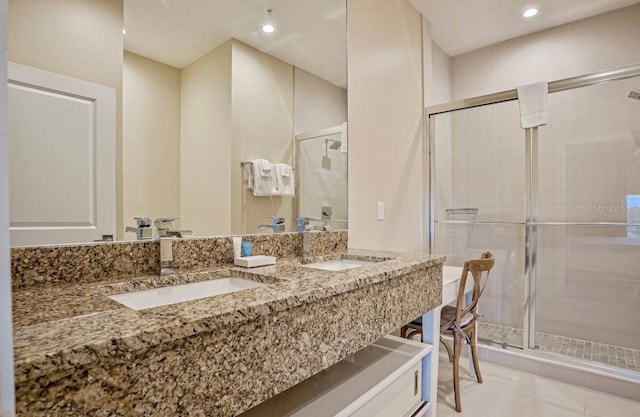 bathroom with vanity, a shower with shower door, and tile patterned flooring