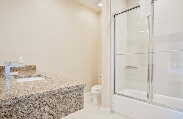 full bathroom with combined bath / shower with glass door, toilet, and sink