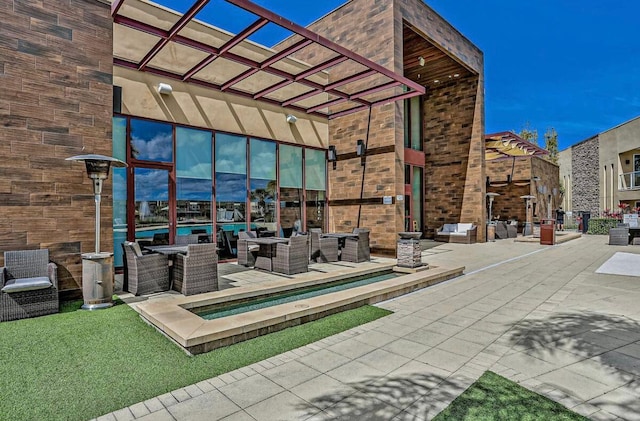 view of patio with an outdoor hangout area and a pergola