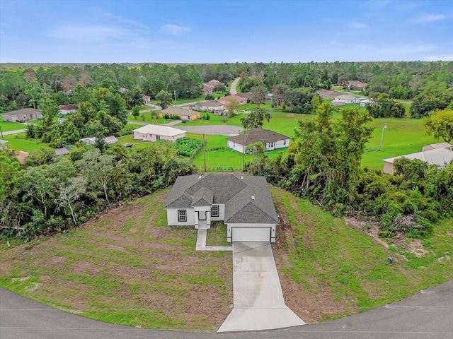 bird's eye view with a wooded view