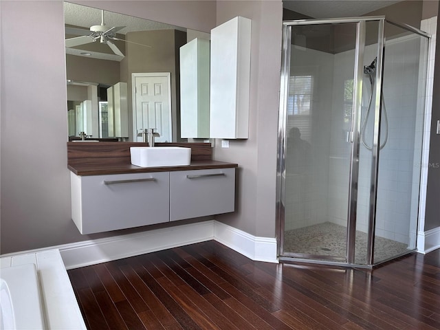 14421 Hatchee Ct, Orlando, FL 32837 - full bath featuring a ceiling fan, wood-type flooring, and a shower stall