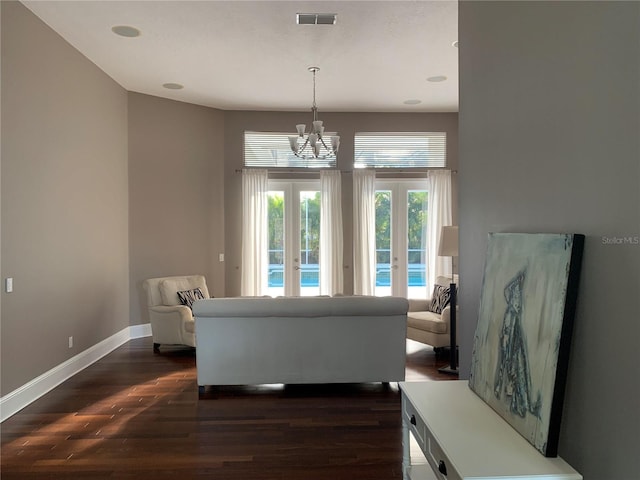 14421 Hatchee Ct, Orlando, FL 32837 - living area featuring visible vents, baseboards, dark wood-style floors, a chandelier, and french doors