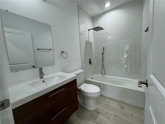 bathroom with wood tiled floor, shower / bathing tub combination, toilet, and vanity