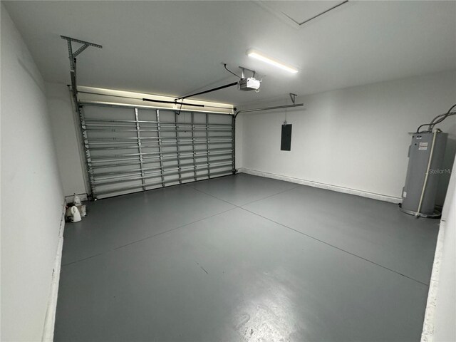 garage featuring water heater, a garage door opener, and electric panel