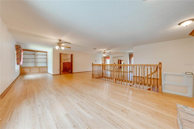 empty room featuring a textured ceiling and hardwood / wood-style flooring