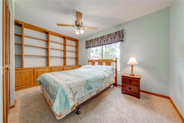 carpeted bedroom with a textured ceiling and ceiling fan