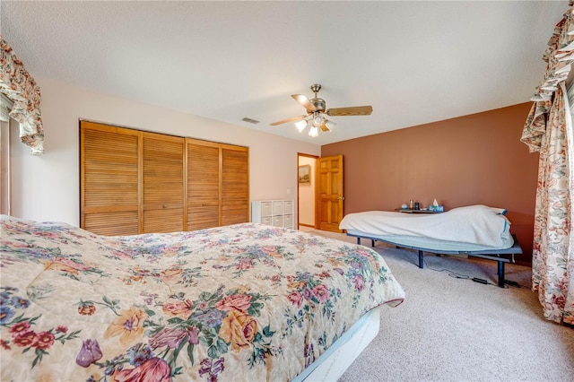 carpeted bedroom with a closet and ceiling fan