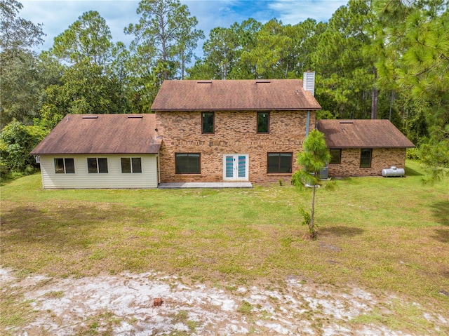 rear view of house featuring a yard and central AC unit