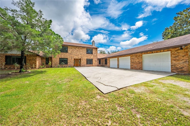 view of front of house with a front yard and a garage