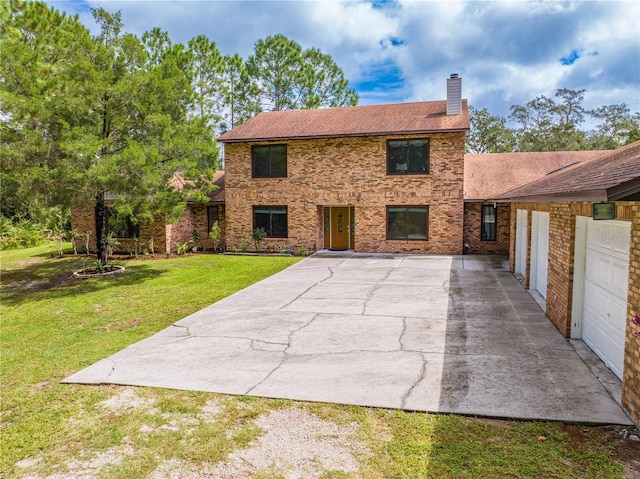 view of front of house with a front lawn and a garage