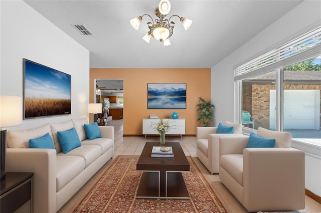 1775 Sundance Dr, Saint Cloud, FL 34771 - living room featuring a chandelier, light tile patterned floors, and baseboards