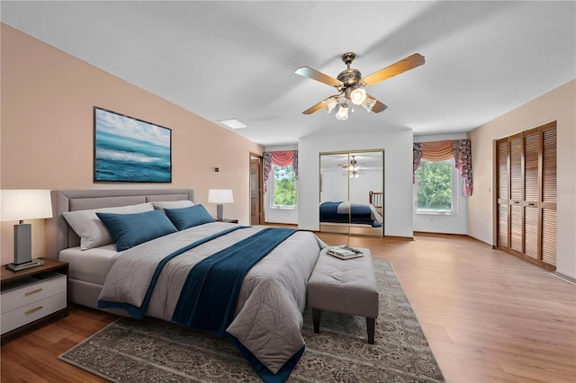 1775 Sundance Dr, Saint Cloud, FL 34771 - bedroom featuring wood finished floors, multiple closets, ceiling fan, and baseboards