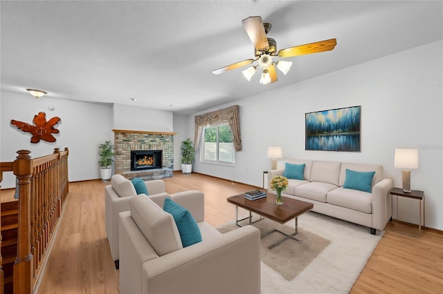 1775 Sundance Dr, Saint Cloud, FL 34771 - living room featuring light wood-type flooring, a ceiling fan, a brick fireplace, and baseboards