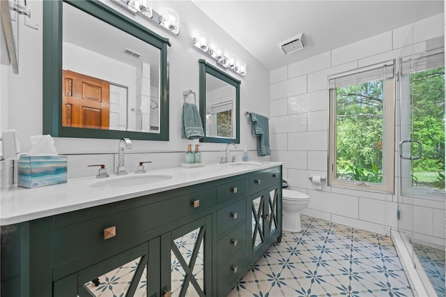 1775 Sundance Dr, Saint Cloud, FL 34771 - full bathroom featuring tile walls, toilet, and double vanity