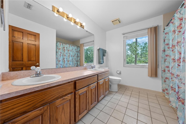 1775 Sundance Dr, Saint Cloud, FL 34771 - full bathroom with tile patterned flooring, double vanity, toilet, and baseboards
