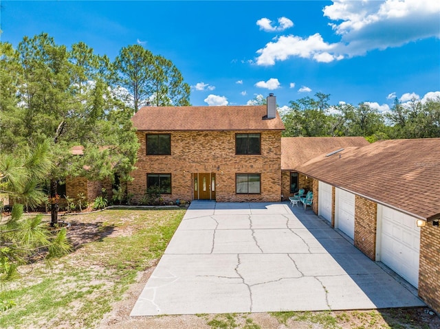 1775 Sundance Dr, Saint Cloud, FL 34771 - view of front facade with brick siding, a chimney, driveway, and a garage