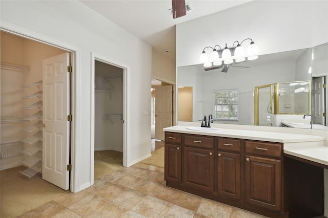 bathroom with vanity, ceiling fan, tile patterned floors, and a shower with shower door