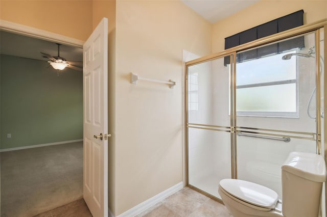 bathroom featuring tile patterned floors, ceiling fan, an enclosed shower, and toilet