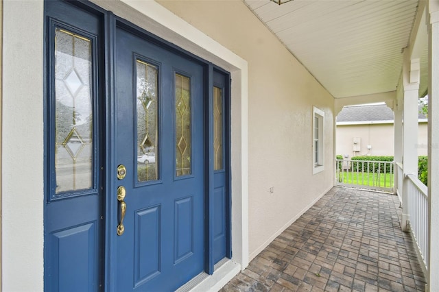 property entrance featuring covered porch