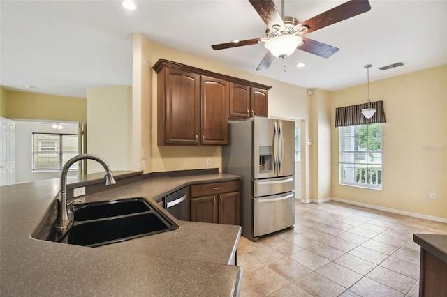 kitchen featuring sink, stainless steel appliances, decorative light fixtures, light tile patterned floors, and ceiling fan