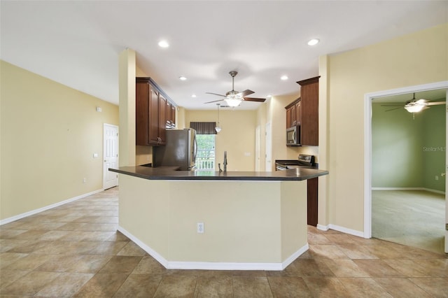 kitchen featuring sink, kitchen peninsula, light carpet, stainless steel appliances, and ceiling fan