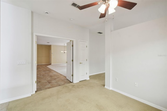 spare room featuring ceiling fan and light carpet