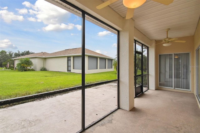 unfurnished sunroom featuring ceiling fan and lofted ceiling