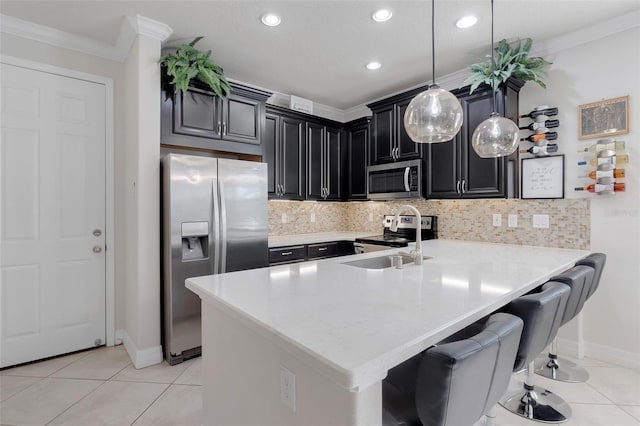 kitchen with a breakfast bar, kitchen peninsula, stainless steel appliances, decorative light fixtures, and crown molding