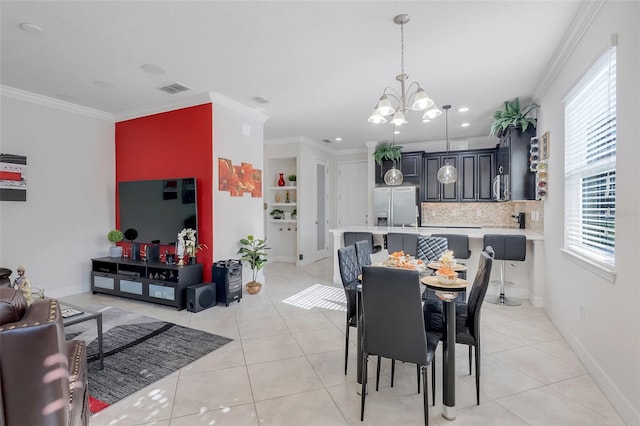 dining area featuring a notable chandelier, light tile patterned flooring, and ornamental molding