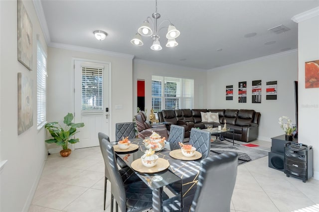 dining space featuring a chandelier, light tile patterned floors, a healthy amount of sunlight, and crown molding