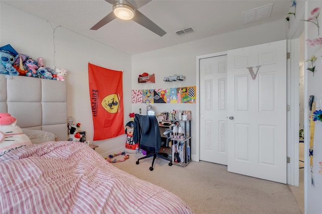 carpeted bedroom featuring ceiling fan and a closet