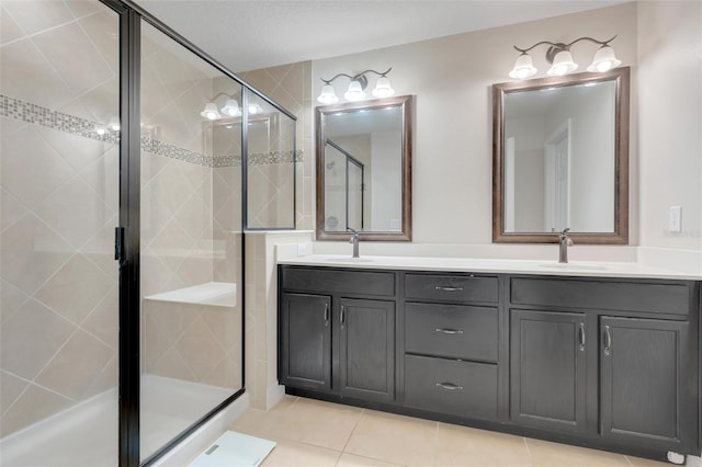 bathroom with tile patterned floors, walk in shower, and vanity