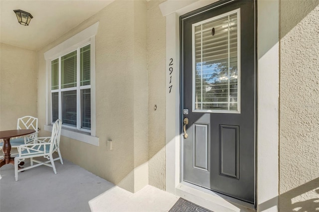 view of exterior entry with a porch